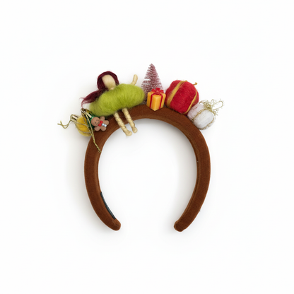 Decorative headband with fairy and Christmas-themed ornaments on a white background