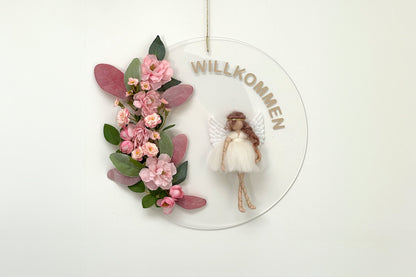 Decorative wall hanging with flowers and an angel figure on a white background