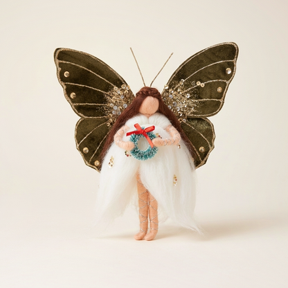 Handcrafted butterfly fairy Christmas ornament with olive green velvet wings and wreath on a seamless warm cream studio cyclorama