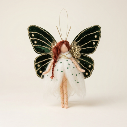 Handmade Emerald Butterfly Fairy hanging ornament with dark green velvet wings on a seamless warm cream studio cyclorama
